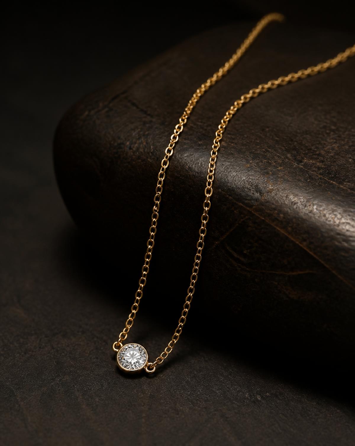 Fine gold chain with a bezel-set round diamond pendant